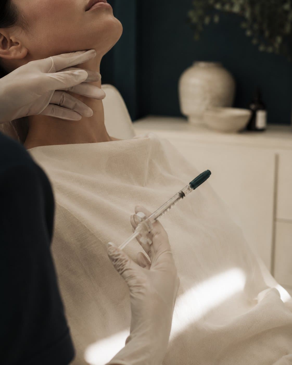 A practitioner assessing beneath a reclined client's chin